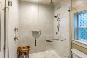 Frameless shower glass door in modern bathroom by Merritt Glass Company