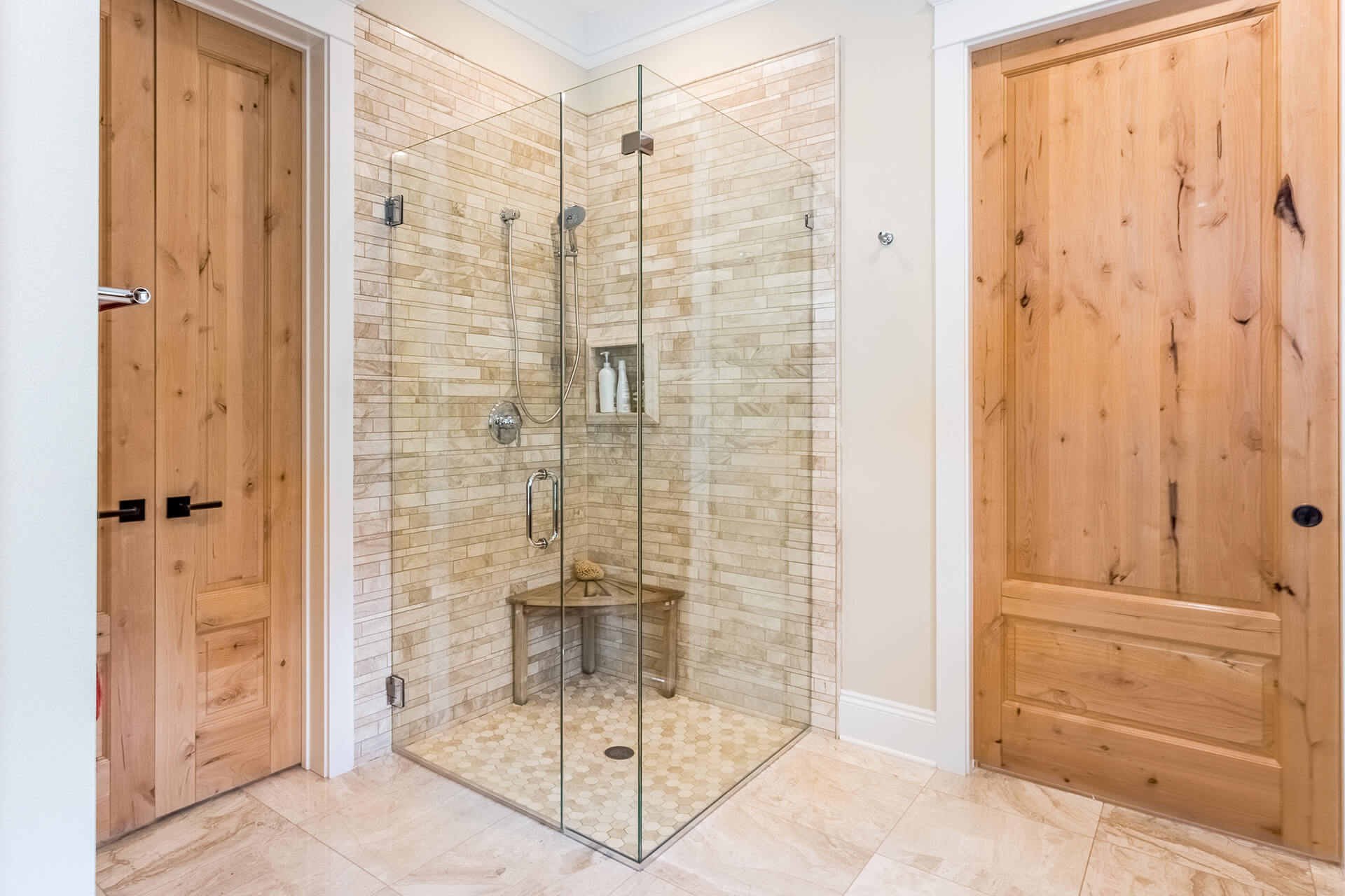 Corner-frameless-glass-shower-enclosure-with-door-and-silver-hardware